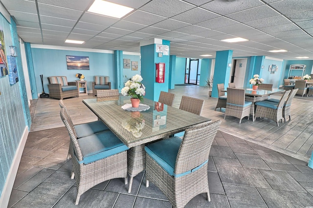 dining area featuring a paneled ceiling