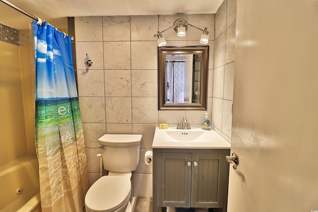 full bathroom with shower / bath combo with shower curtain, tile walls, toilet, and vanity