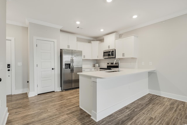 kitchen with hardwood / wood-style floors, white cabinetry, sink, and stainless steel appliances