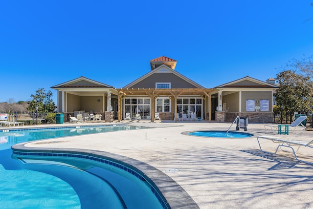 view of pool featuring a patio and a hot tub