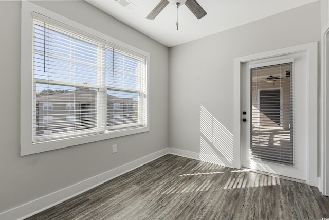 unfurnished room with ceiling fan and dark hardwood / wood-style flooring