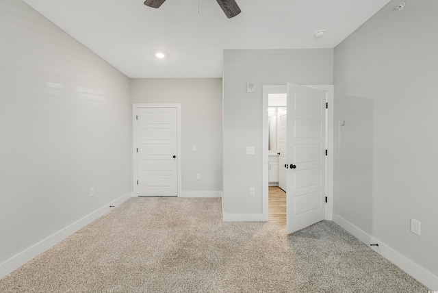 unfurnished bedroom with ceiling fan and light colored carpet