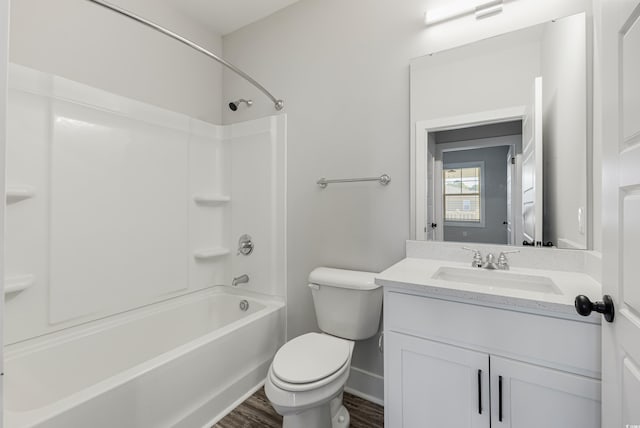 full bathroom featuring toilet, hardwood / wood-style floors, vanity, and bathing tub / shower combination