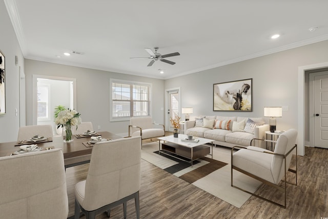 living room with hardwood / wood-style flooring, ceiling fan, and crown molding