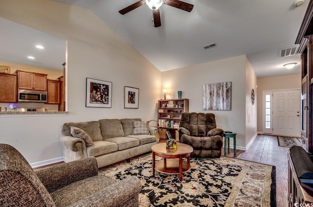 living room with ceiling fan, lofted ceiling, and light wood-type flooring