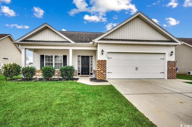 view of front of property with a front yard and a garage