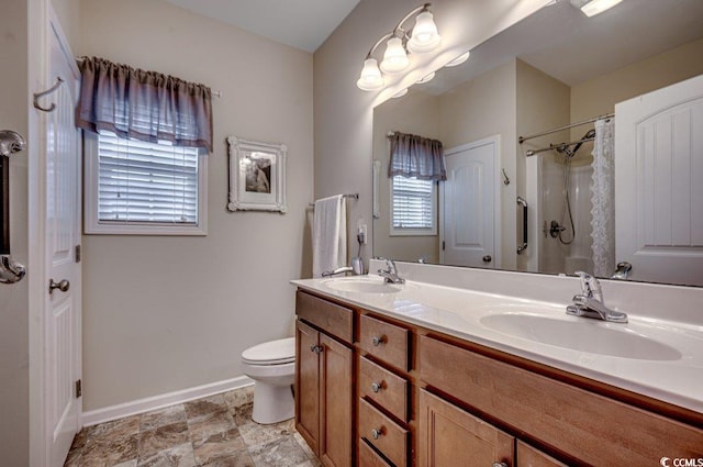 bathroom featuring a shower with curtain, vanity, and toilet