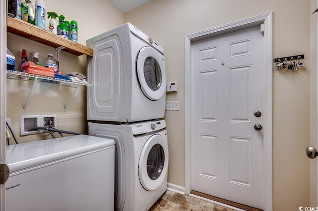 laundry area featuring stacked washing maching and dryer