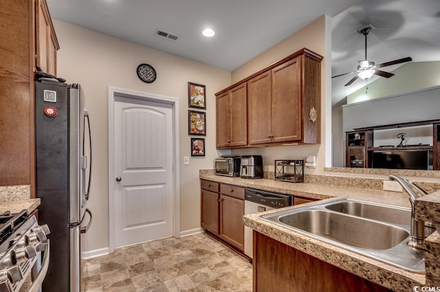 kitchen featuring stainless steel appliances, vaulted ceiling, ceiling fan, and sink