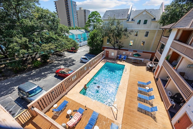 view of swimming pool featuring a wooden deck and a patio area