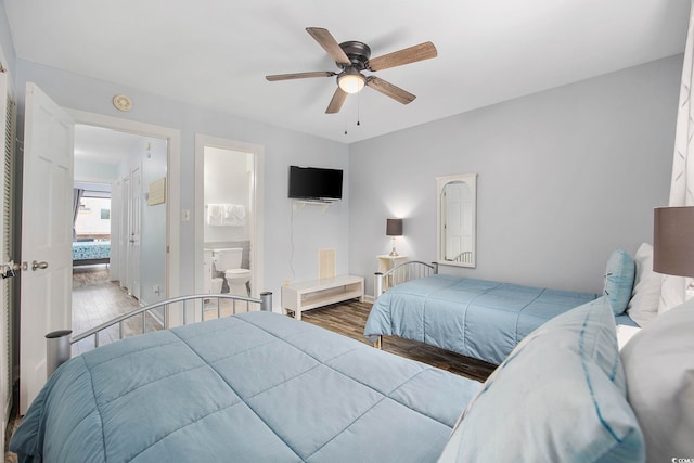 bedroom featuring connected bathroom, wood-type flooring, and ceiling fan