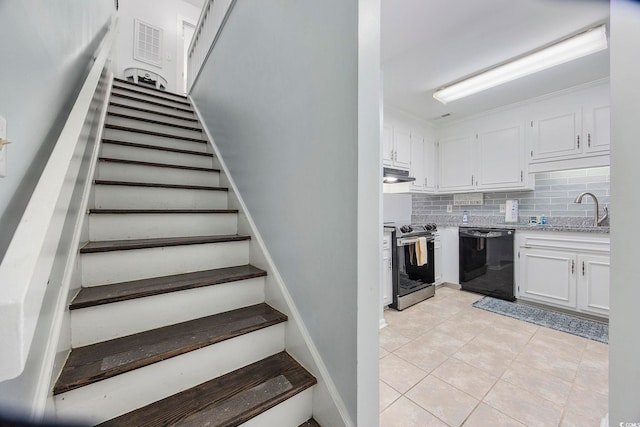 staircase with tile patterned floors and sink