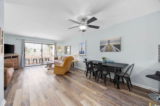 dining area with hardwood / wood-style flooring and ceiling fan