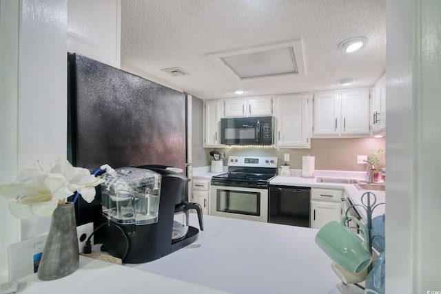 kitchen with white cabinets, black appliances, and a textured ceiling