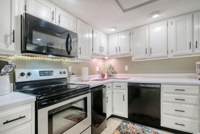 kitchen featuring black appliances, sink, light tile patterned floors, a textured ceiling, and white cabinetry