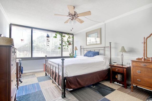 bedroom featuring a textured ceiling, ceiling fan, and crown molding