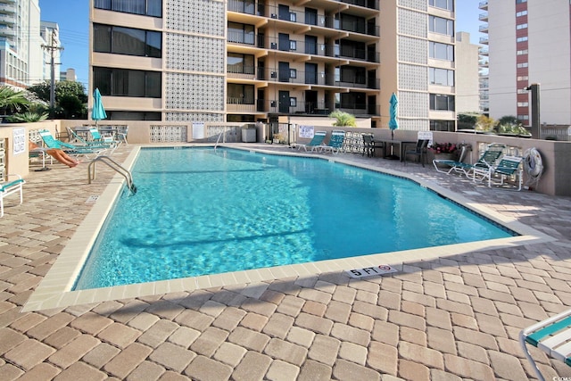 view of swimming pool with a patio area