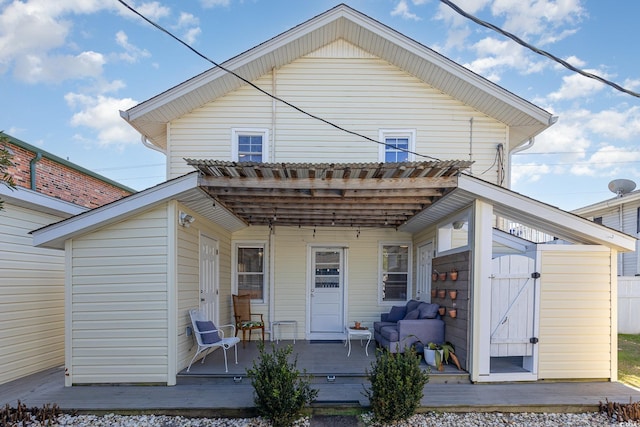 back of house featuring a wooden deck