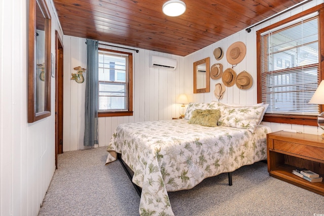 bedroom featuring carpet flooring, wood walls, a wall unit AC, and wooden ceiling