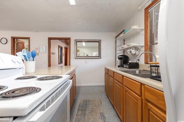 kitchen with white range with electric stovetop and sink