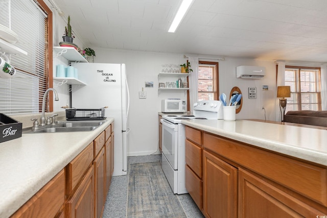 kitchen featuring white appliances, sink, and a wall mounted AC