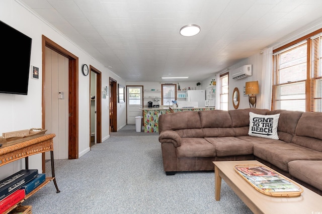 carpeted living room with a wall unit AC