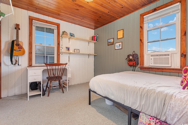 carpeted bedroom featuring cooling unit, wooden ceiling, and wooden walls