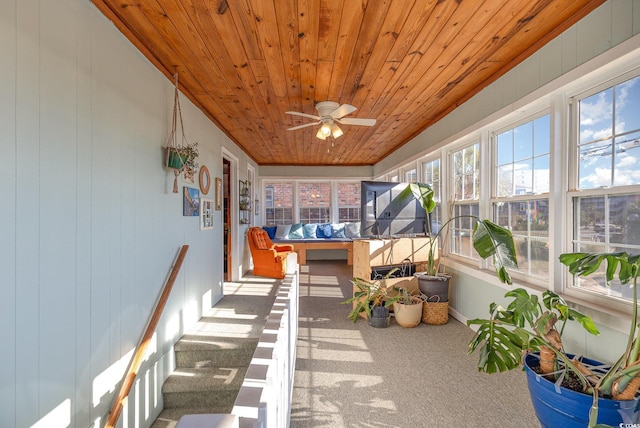 sunroom / solarium featuring ceiling fan and wooden ceiling