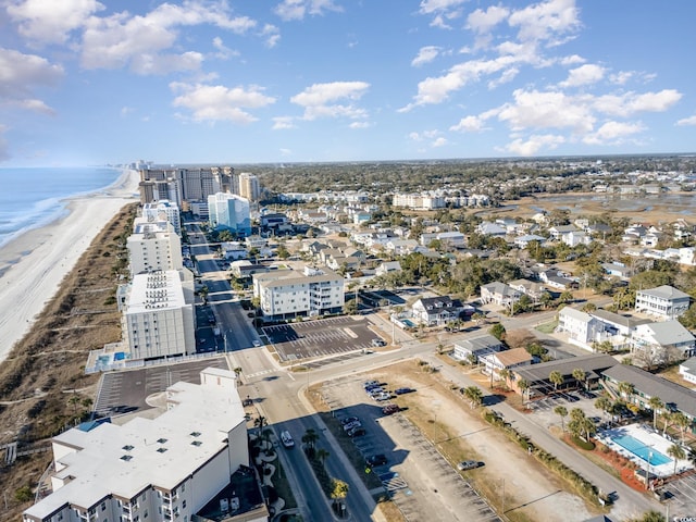 drone / aerial view featuring a beach view and a water view