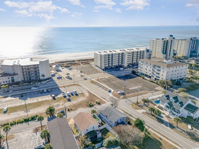 aerial view with a water view and a view of the beach