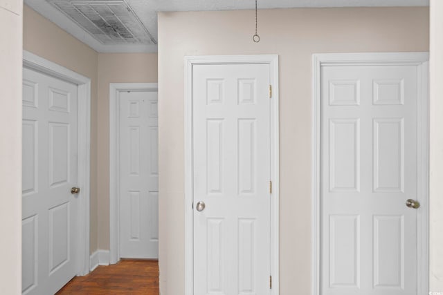 corridor with dark hardwood / wood-style floors