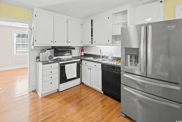 kitchen featuring electric range, dishwasher, sink, stainless steel refrigerator with ice dispenser, and white cabinets