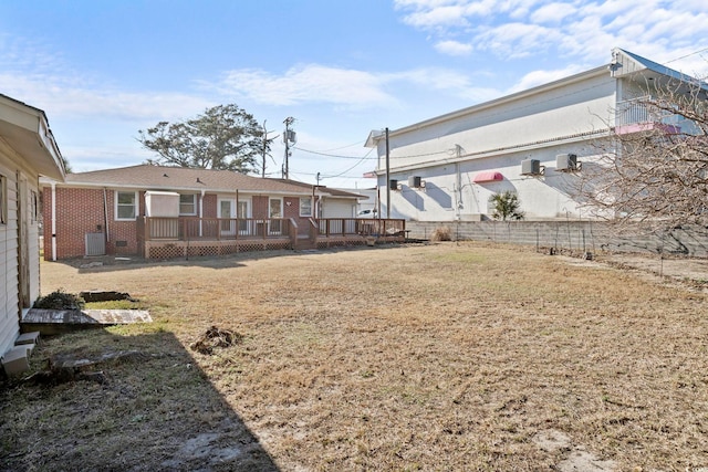 view of yard featuring central AC unit and a deck