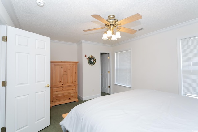 carpeted bedroom with ceiling fan, crown molding, and a textured ceiling