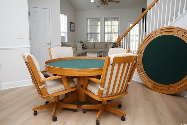 dining area featuring light hardwood / wood-style flooring, vaulted ceiling, and a wealth of natural light