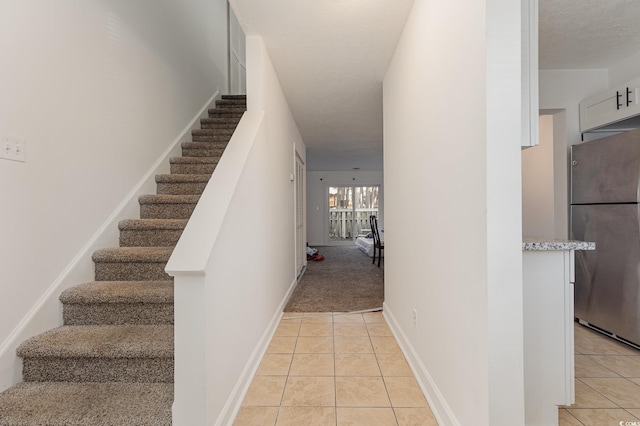 stairway with tile patterned flooring