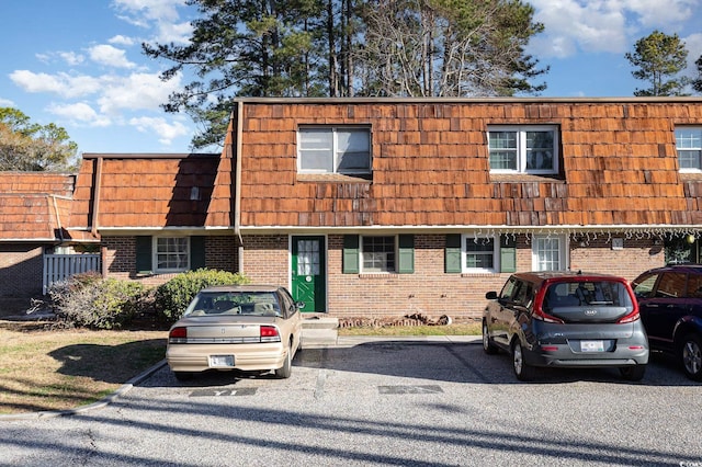 1025 Carolina Rd Unit Y-1, Conway, SC 29526 - view of property featuring mansard roof, uncovered parking, and brick siding