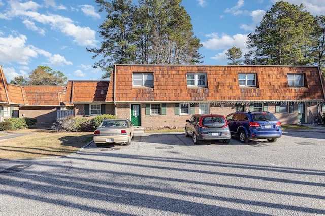 1025 Carolina Rd Unit Y-1, Conway, SC 29526 - view of front of home with mansard roof, uncovered parking, and brick siding