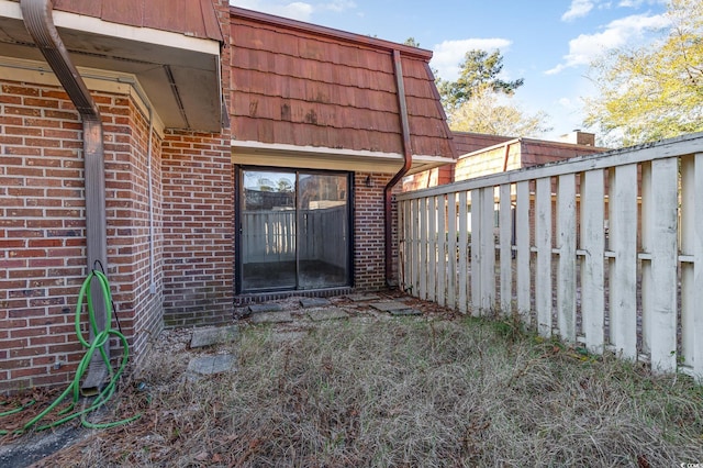 1025 Carolina Rd Unit Y-1, Conway, SC 29526 - exterior space with fence, mansard roof, and brick siding