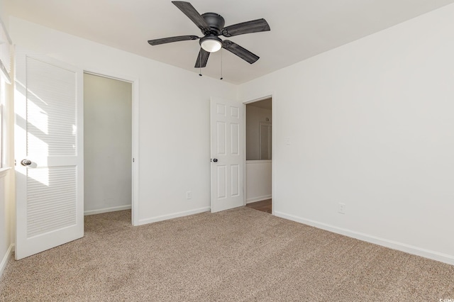 unfurnished bedroom with light colored carpet, a closet, and ceiling fan