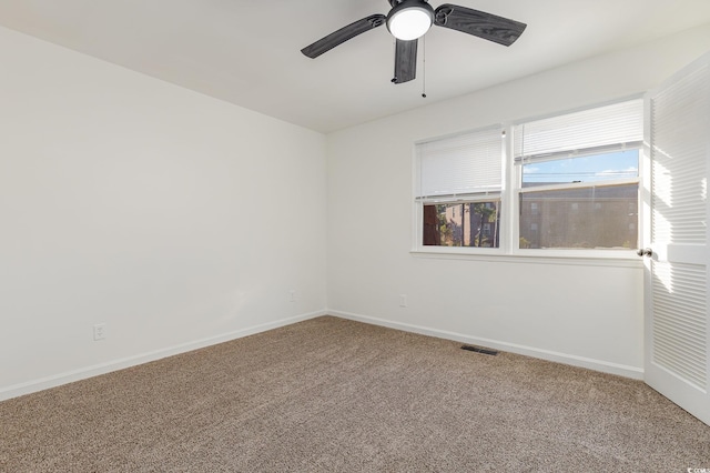 spare room with carpet flooring and ceiling fan