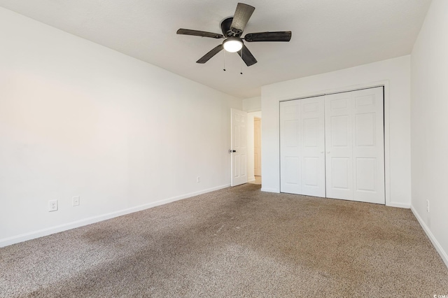 unfurnished bedroom with ceiling fan, carpet, and a closet