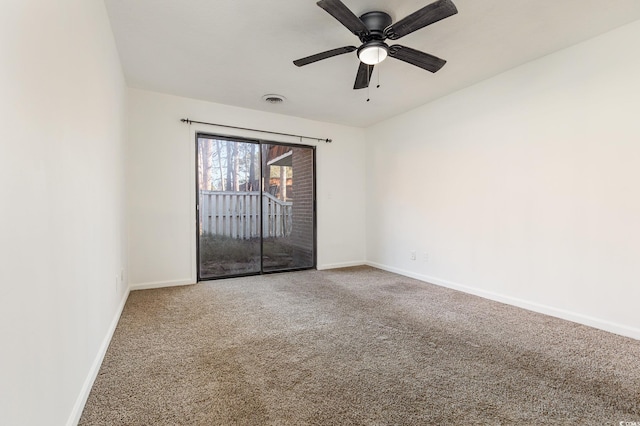 carpeted spare room featuring ceiling fan