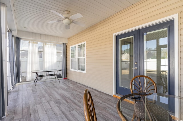 unfurnished sunroom featuring french doors and ceiling fan