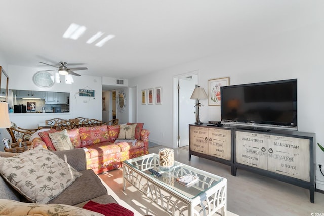 living room with ceiling fan and light wood-type flooring