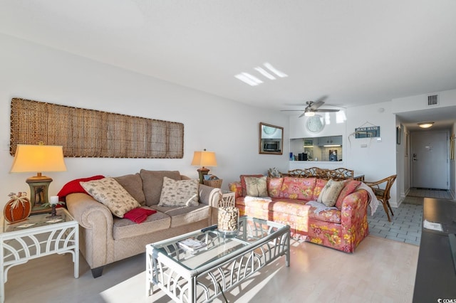 living room with ceiling fan and wood-type flooring