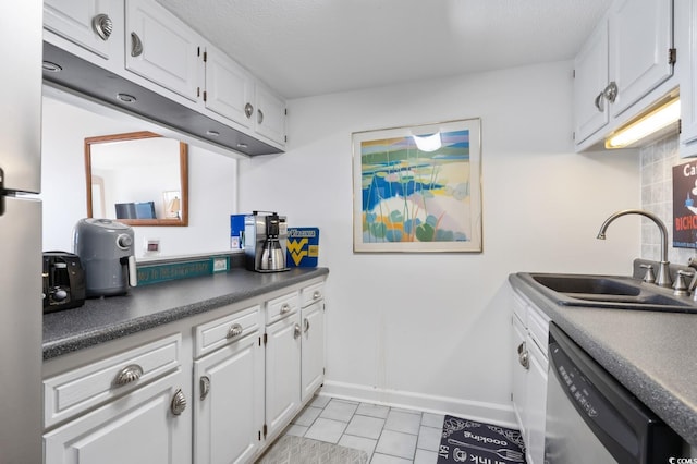 kitchen featuring decorative backsplash, stainless steel dishwasher, sink, white cabinetry, and light tile patterned flooring