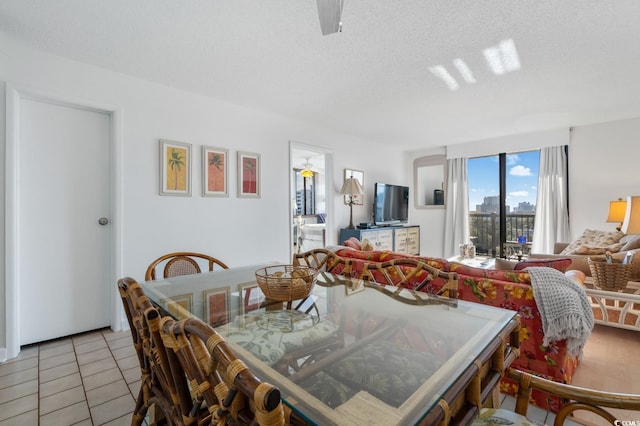 tiled dining area featuring a textured ceiling