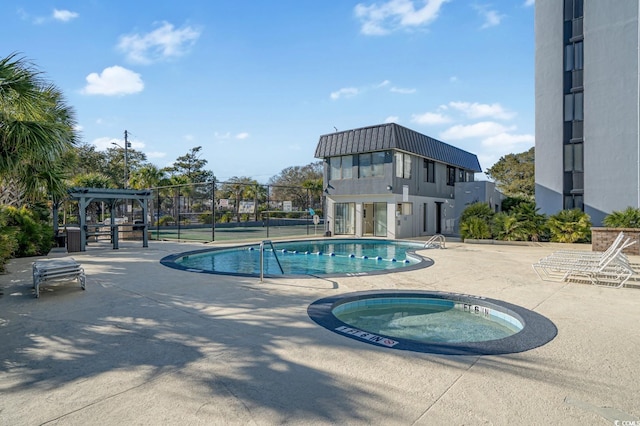 view of pool with a pergola, a community hot tub, and a patio