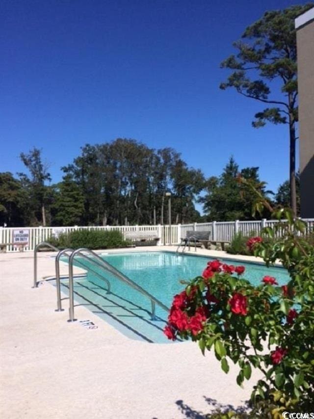 pool with fence and a patio